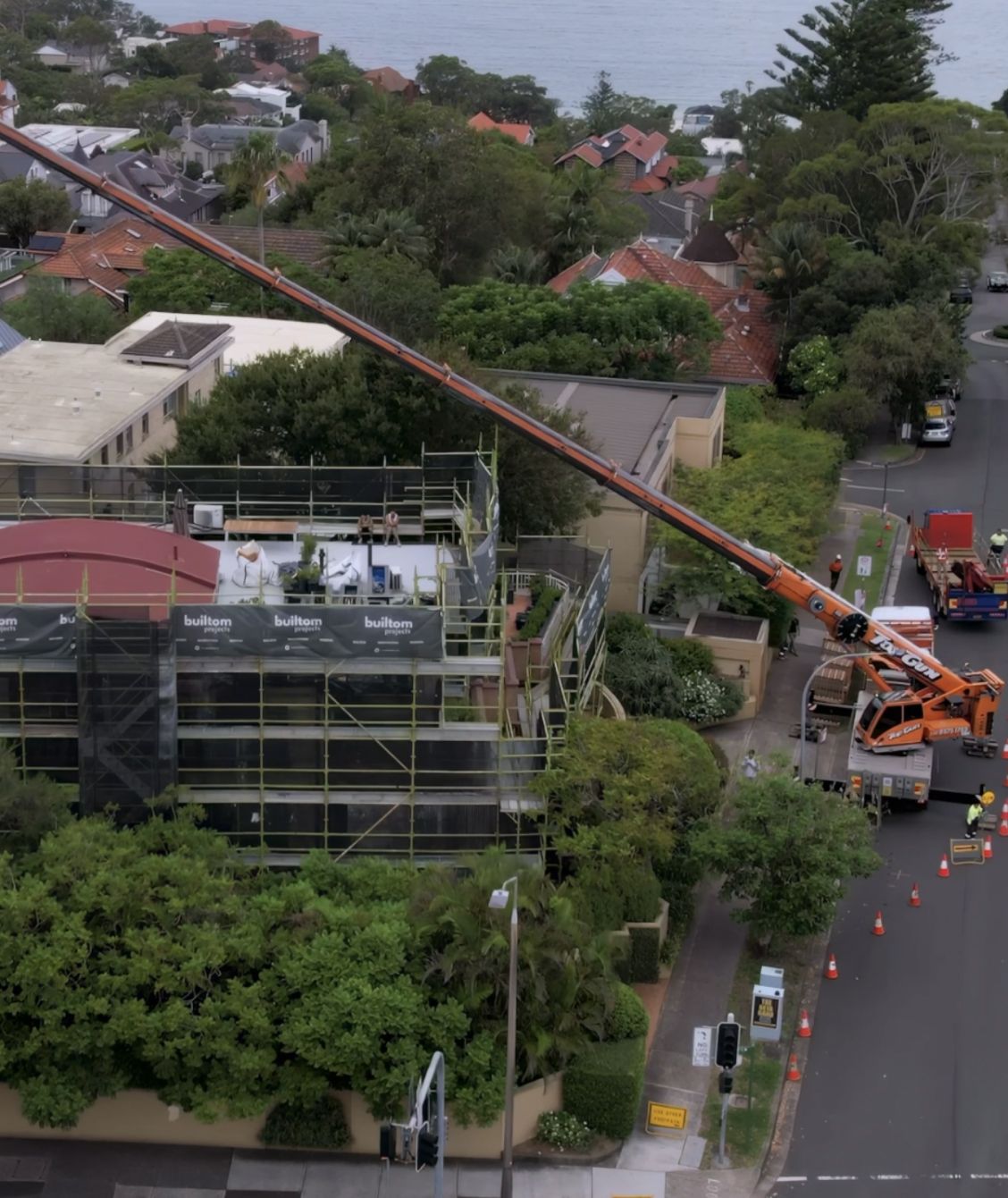Aerial view of remedial works with scaffolding and a crane at a Sydney property